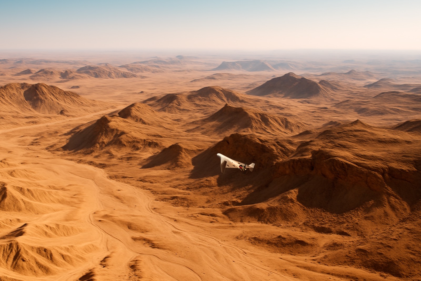Aircraft over desert dunes
